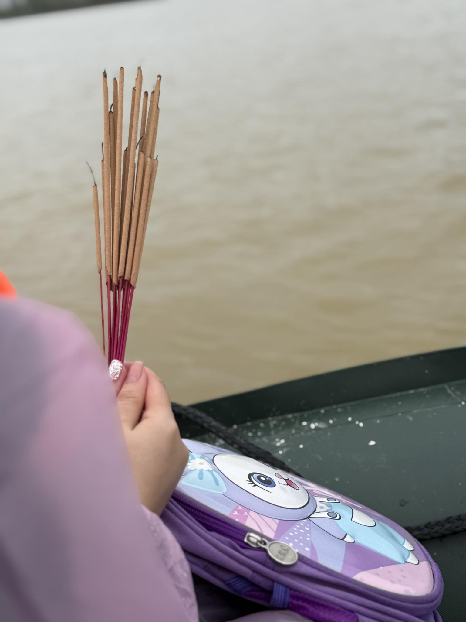 H&igrave;nh ảnh chị Y. cầm hương, mang theo đồ d&ugrave;ng của con ngồi tr&ecirc;n thuyền t&igrave;m kiếm 3 bố con